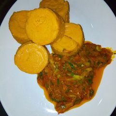 Moin moin with palm oil sauce A picture of Moin moin with palm oil sauce.