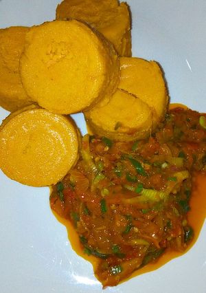 A picture of Moin moin with palm oil sauce.