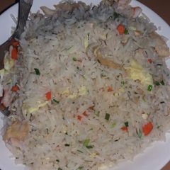 A picture of Fried rice with scrambled eggs and mix vegetables.