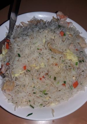 A picture of Fried rice with scrambled eggs and mix vegetables.