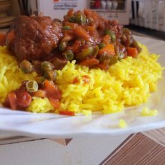 A picture of Turmeric Rice And Meat Balls with  Peas.