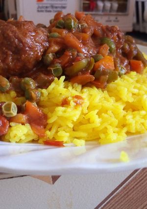 A picture of Turmeric Rice And Meat Balls with Peas.