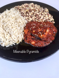 A picture of Rice and beans with hot sauce.