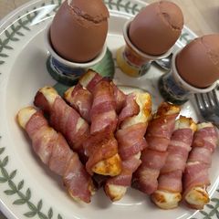 A picture of Bacon-Wrapped Halloumi with Soft-Boiled Eggs.