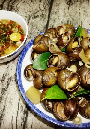 A picture of Steamed Snails with Lemongrass and Lime Leaves - Ginger Fish Sauce Dip.