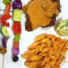 A picture of Beef steak with pasta.