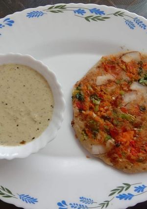 A picture of Veggie Uttapam with Peanut Chutney.