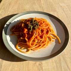 A picture of Bucatini with tuna, tomatoes and anchovies sambal topping.