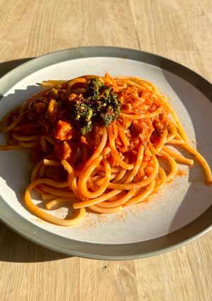 A picture of Bucatini with tuna, tomatoes and anchovies sambal topping.
