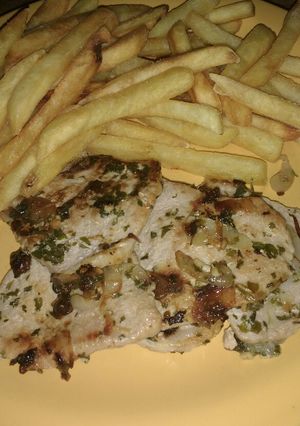 Una foto de Churrasquitos de cerdo con albahaca y papas fritas
