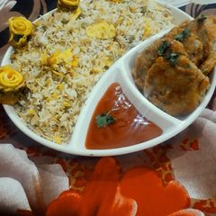 A picture of Capsicum and chicken pulao with potato kabab platter.