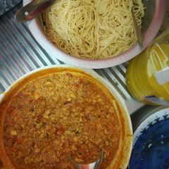 A picture of Spaghetti and egg tomato curry.