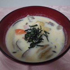 A picture of Pork miso soup with mushrooms and milk.