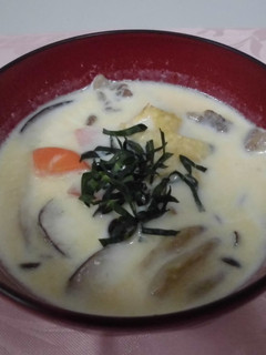 A picture of Pork miso soup with mushrooms and milk.