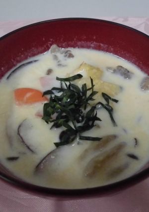 A picture of Pork miso soup with mushrooms and milk.