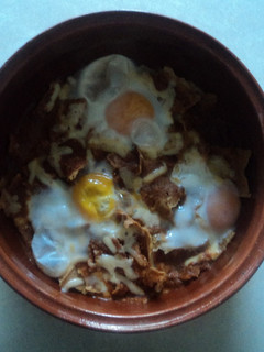 Una foto de Otros chilaquiles de chiles secos, pollo, hoja santa, pulque y huevos estrellados
