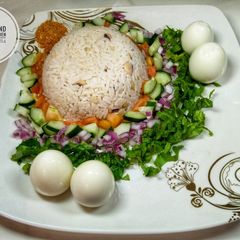 A picture of Rice and beans with salad.
