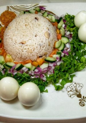 A picture of Rice and beans with salad.