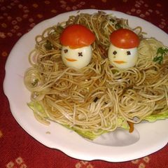 A picture of Atta garlic noodles with boiled eggs.