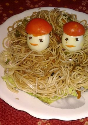 A picture of Atta garlic noodles with boiled eggs.