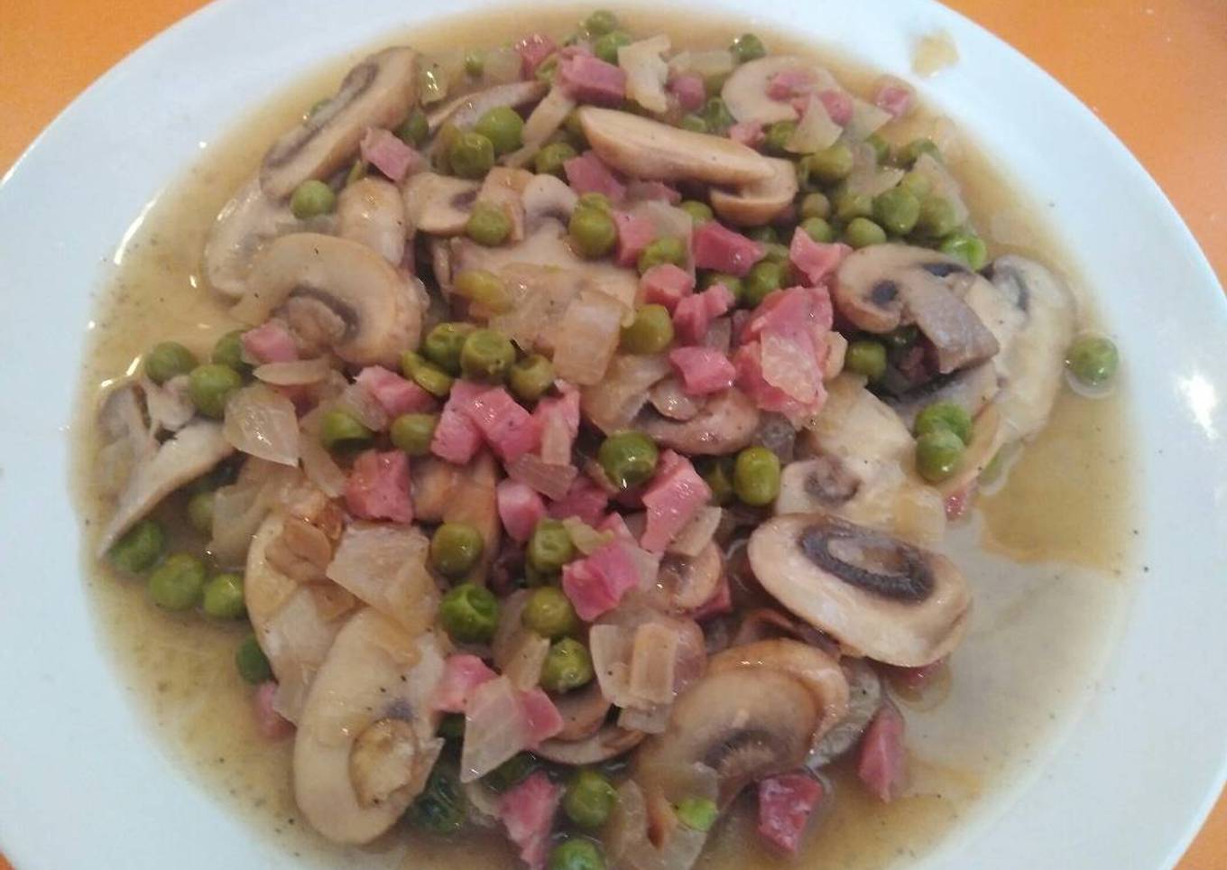 Champiñones con guisantes y jamón