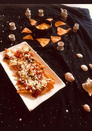 A picture of Veg Nachos with cheesy Dip.