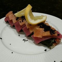 A picture of Brad's lobster, ahi tuna, and smoked salmon sushi roll.