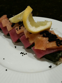 A picture of Brad's lobster, ahi tuna, and smoked salmon sushi roll.