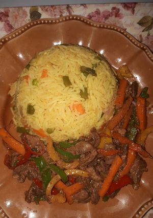 A picture of Fried rice and beef stir fry.