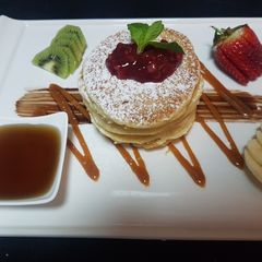 A picture of Pancake stack with maple syrup.