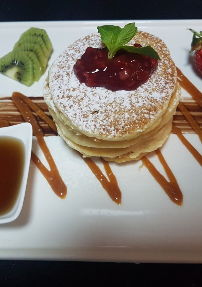 A picture of Pancake stack with maple syrup.