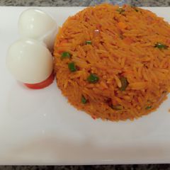 A picture of Jellof rice and boiled egg.