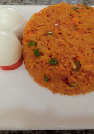 A picture of Jellof rice and boiled egg.