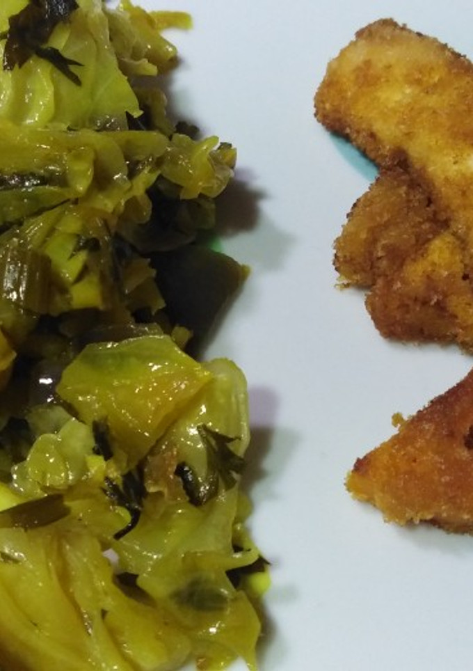 Una foto de Pollo rebozado con col salteada
