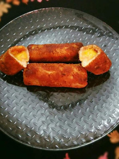 A picture of Bread toast roll ups with mango stuffing.