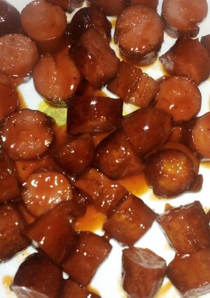 A picture of Sausages in sauce.