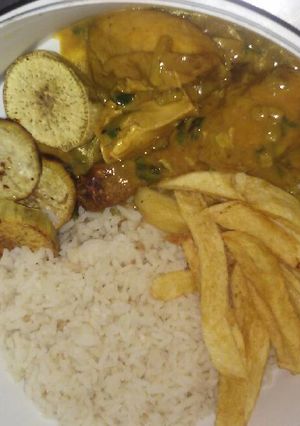 Una foto de Pollo al curry con papas, batatas al horno y arroz