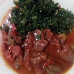 A picture of Stewed meat with greens.