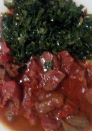 A picture of Stewed meat with greens.