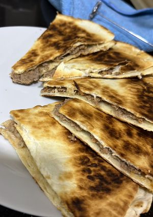 A picture of Lahm Bi Ajeen with Tortilla Bread.
