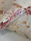 Speck, brie and red onion piadina