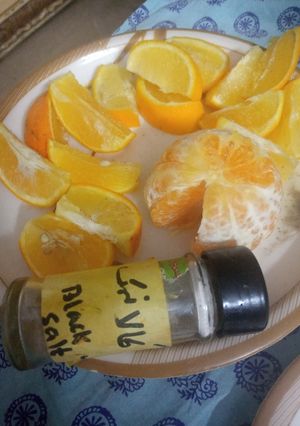 A picture of Fruits with black salt.