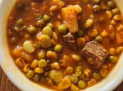 A picture of vegetable soup with bones