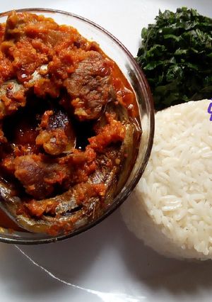 A picture of Palm oil stew paired with white rice.