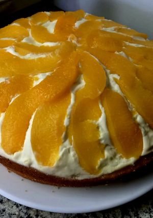 Una foto de Torta bizcocho de vainilla con duraznos, crema y dulce de leche