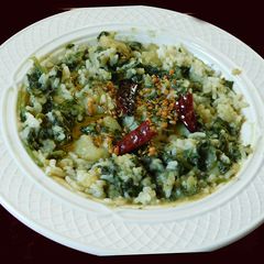 A picture of Spinach potato koottu with rice.