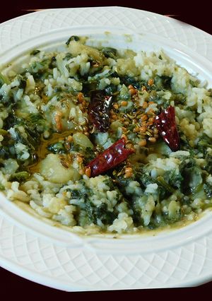 A picture of Spinach potato koottu with rice.
