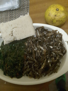 A picture of Dry fried Omena, and Kales with Ugali.