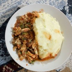 A picture of Smashed potatoes and boneless chicken.
