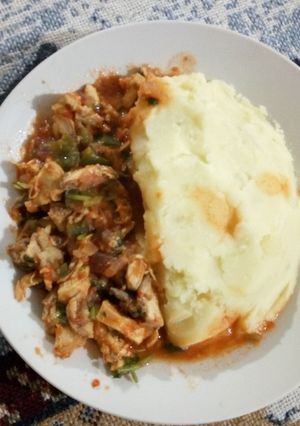 A picture of Smashed potatoes and boneless chicken.
